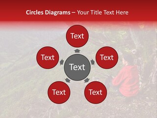 A Man Sitting On Top Of A Mountain Next To A Tree PowerPoint Template