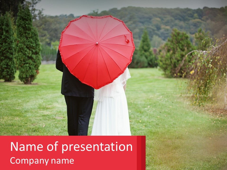 A Bride And Groom Holding A Red Umbrella PowerPoint Template