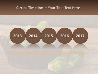A Basket Of Brussel Sprouts On A Wooden Table PowerPoint Template
