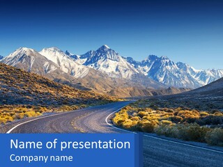 A Road In The Middle Of A Mountain Range PowerPoint Template