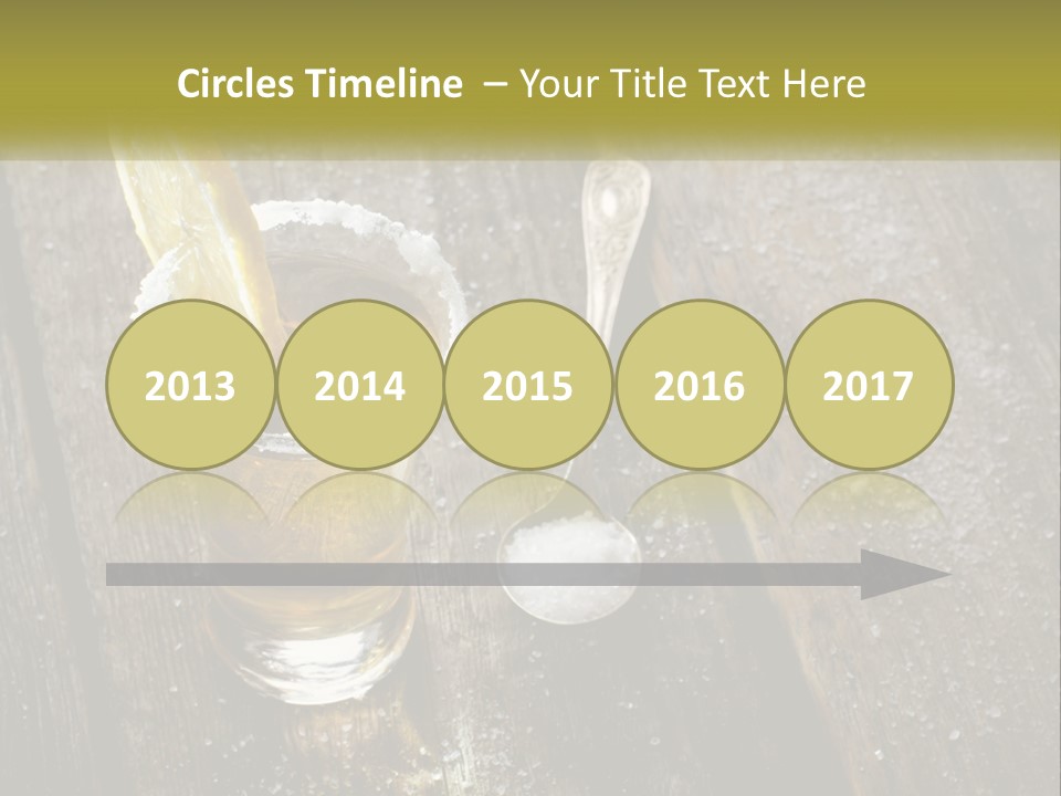 A Glass Of Ice Tea With A Spoon On A Wooden Table PowerPoint Template