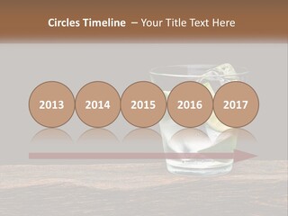 A Glass Of Water With Limes And Ice On A Wooden Table PowerPoint Template