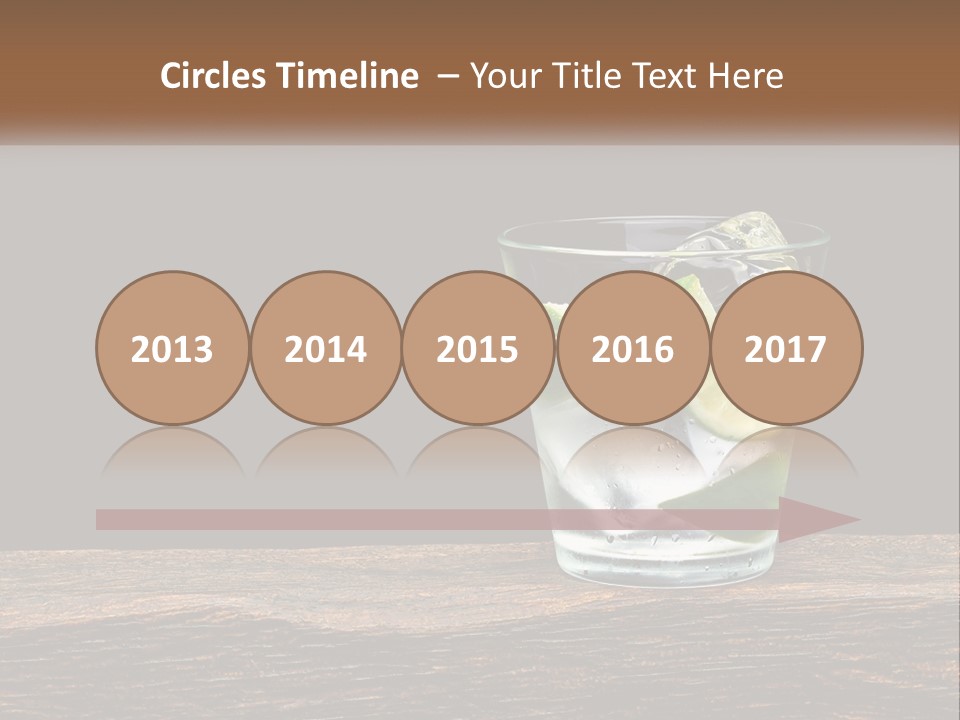 A Glass Of Water With Limes And Ice On A Wooden Table PowerPoint Template