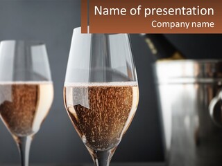 A Couple Of Wine Glasses Sitting On Top Of A Table PowerPoint Template