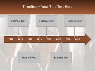A Couple Of Wine Glasses Sitting On Top Of A Table PowerPoint Template