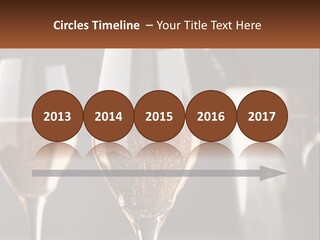 A Couple Of Wine Glasses Sitting On Top Of A Table PowerPoint Template