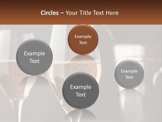A Couple Of Wine Glasses Sitting On Top Of A Table PowerPoint Template