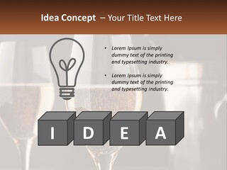 A Couple Of Wine Glasses Sitting On Top Of A Table PowerPoint Template