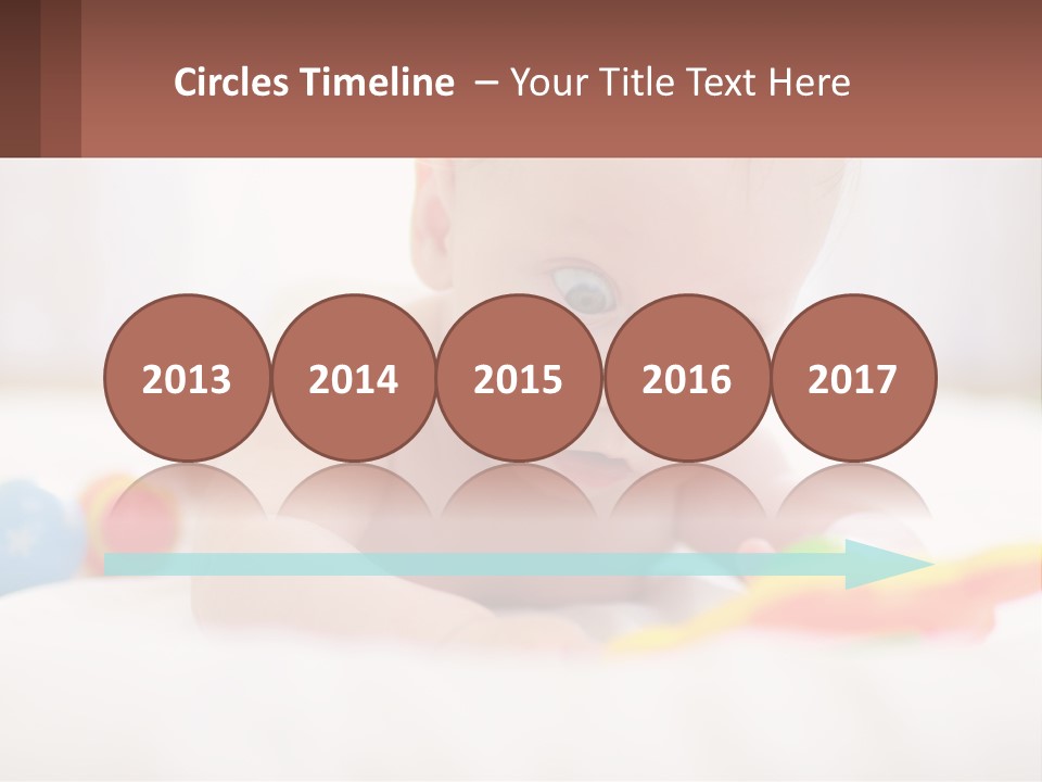 A Baby Laying On A Bed With A Toy PowerPoint Template