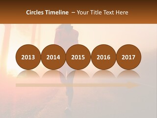 A Woman Running Down A Road With The Sun Setting In The Background PowerPoint Template