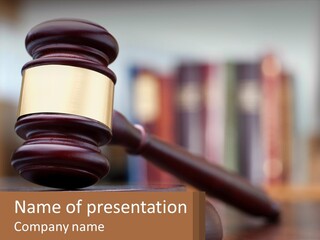 A Wooden Judge's Hammer On Top Of A Table PowerPoint Template