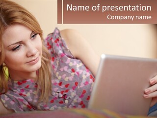 A Woman Laying On A Bed Using A Laptop Computer PowerPoint Template