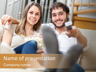 A Man And Woman Sitting On A Couch With A Remote Control PowerPoint Template