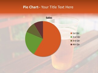 A Glass Of Beer Sitting On Top Of A Wooden Table PowerPoint Template