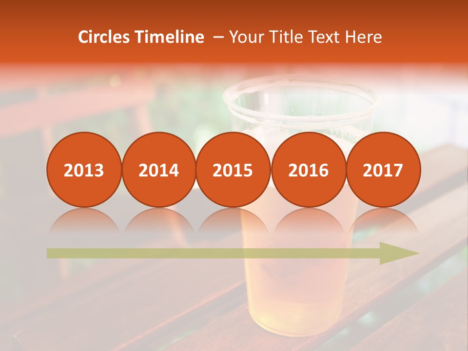 A Glass Of Beer Sitting On Top Of A Wooden Table PowerPoint Template