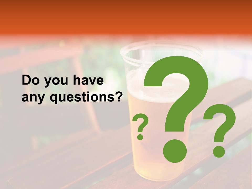 A Glass Of Beer Sitting On Top Of A Wooden Table PowerPoint Template