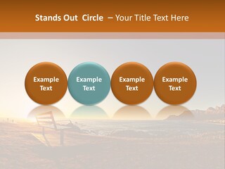 A Bench Sitting On Top Of A Sandy Beach PowerPoint Template