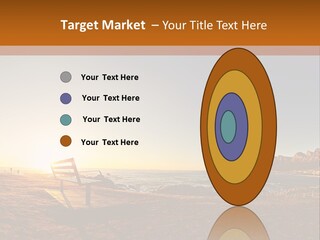 A Bench Sitting On Top Of A Sandy Beach PowerPoint Template
