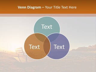 A Bench Sitting On Top Of A Sandy Beach PowerPoint Template