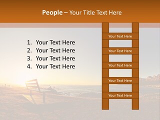 A Bench Sitting On Top Of A Sandy Beach PowerPoint Template