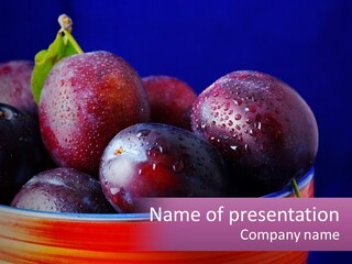 A Bowl Of Plums With Water Droplets On Them PowerPoint Template