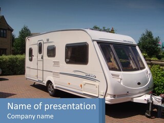 A White Motor Home Parked In A Driveway PowerPoint Template