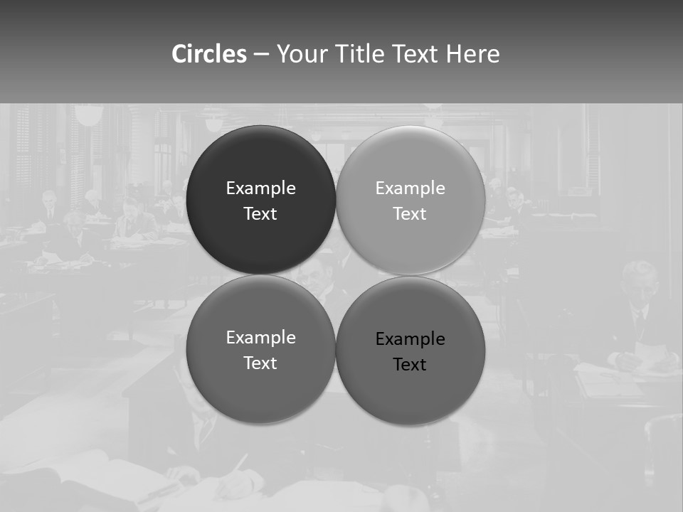 A Group Of People Sitting At Desks In A Room PowerPoint Template