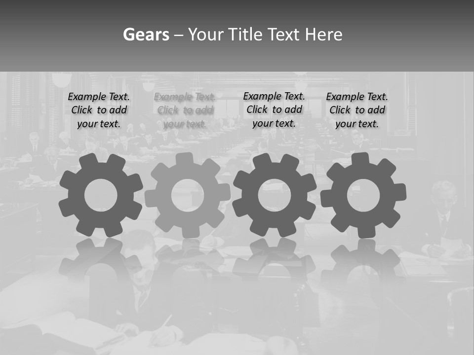 A Group Of People Sitting At Desks In A Room PowerPoint Template