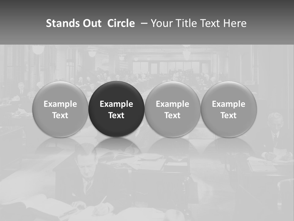 A Group Of People Sitting At Desks In A Room PowerPoint Template