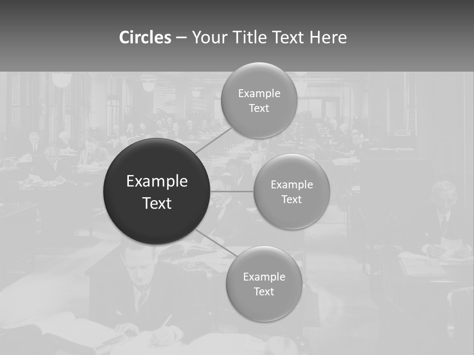 A Group Of People Sitting At Desks In A Room PowerPoint Template