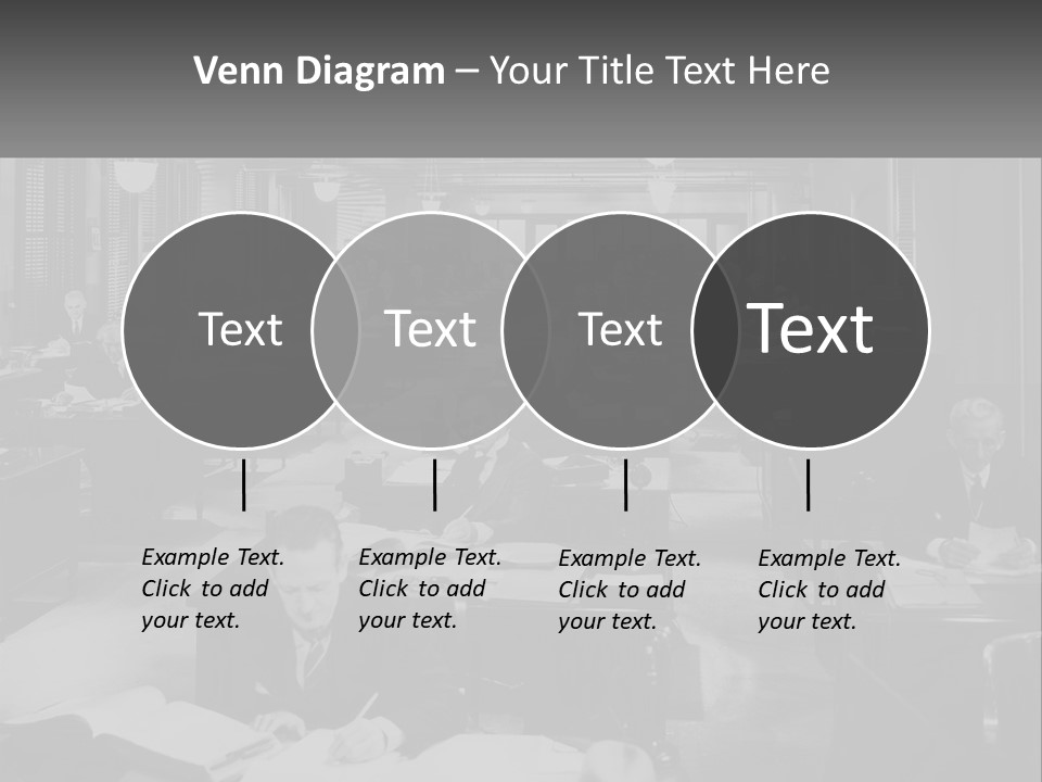 A Group Of People Sitting At Desks In A Room PowerPoint Template