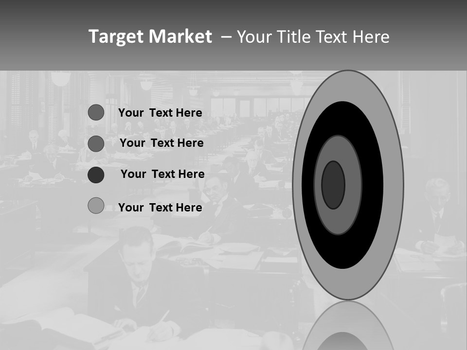 A Group Of People Sitting At Desks In A Room PowerPoint Template