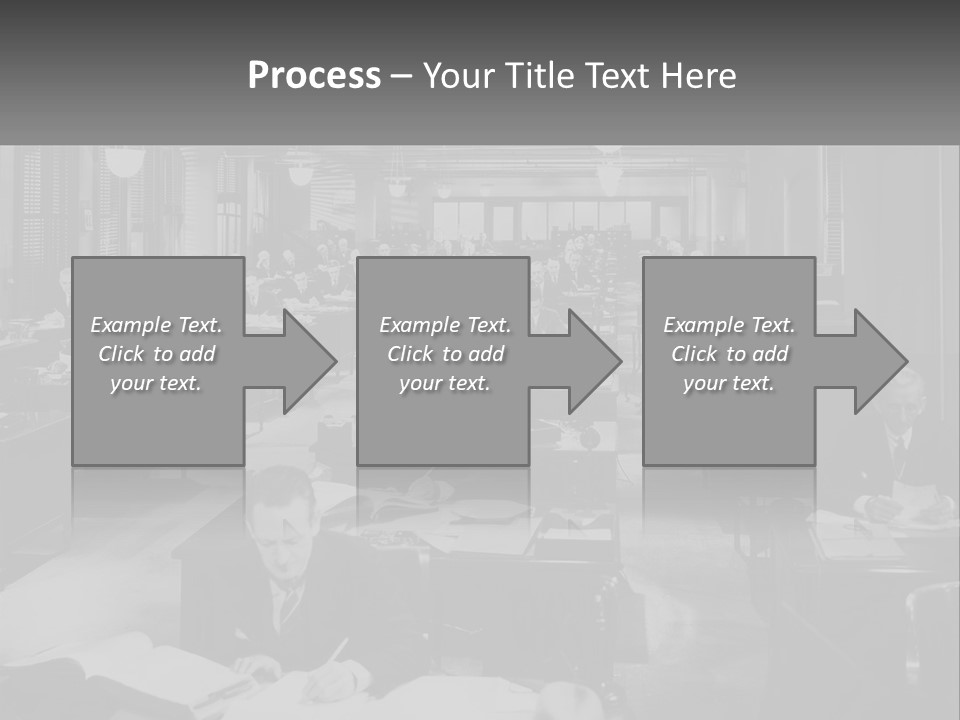 A Group Of People Sitting At Desks In A Room PowerPoint Template