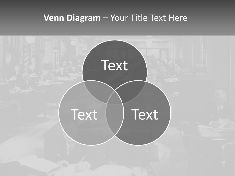 A Group Of People Sitting At Desks In A Room PowerPoint Template