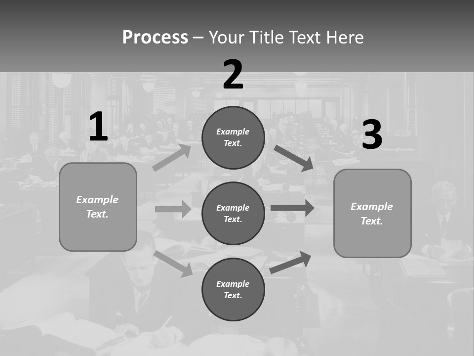 A Group Of People Sitting At Desks In A Room PowerPoint Template