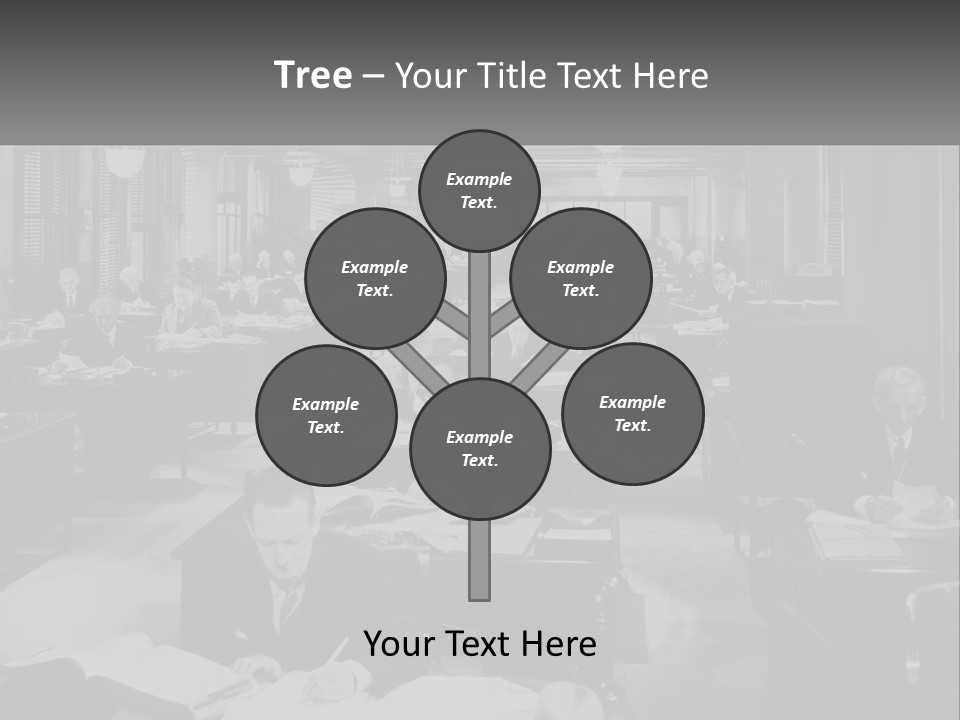 A Group Of People Sitting At Desks In A Room PowerPoint Template