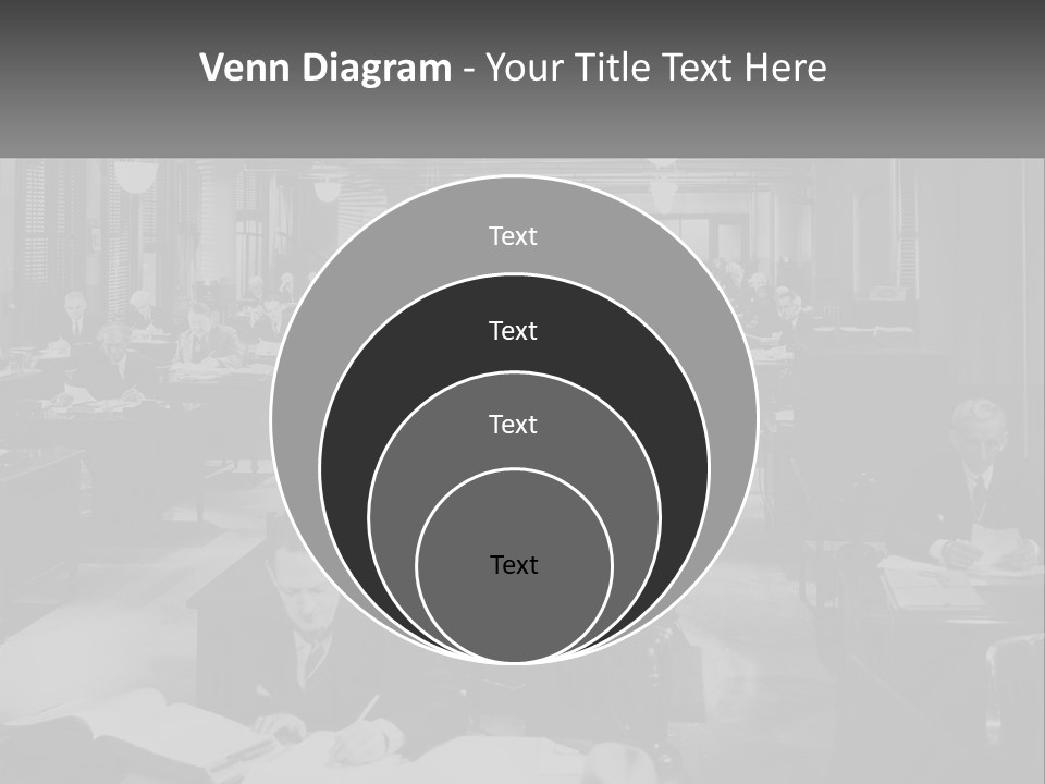 A Group Of People Sitting At Desks In A Room PowerPoint Template