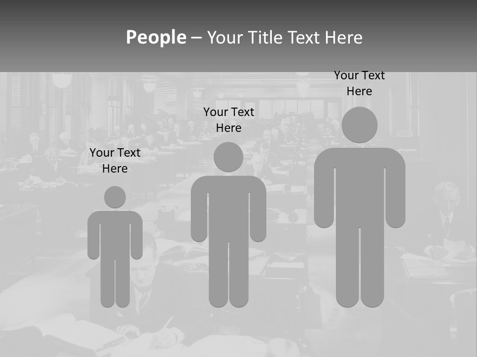 A Group Of People Sitting At Desks In A Room PowerPoint Template