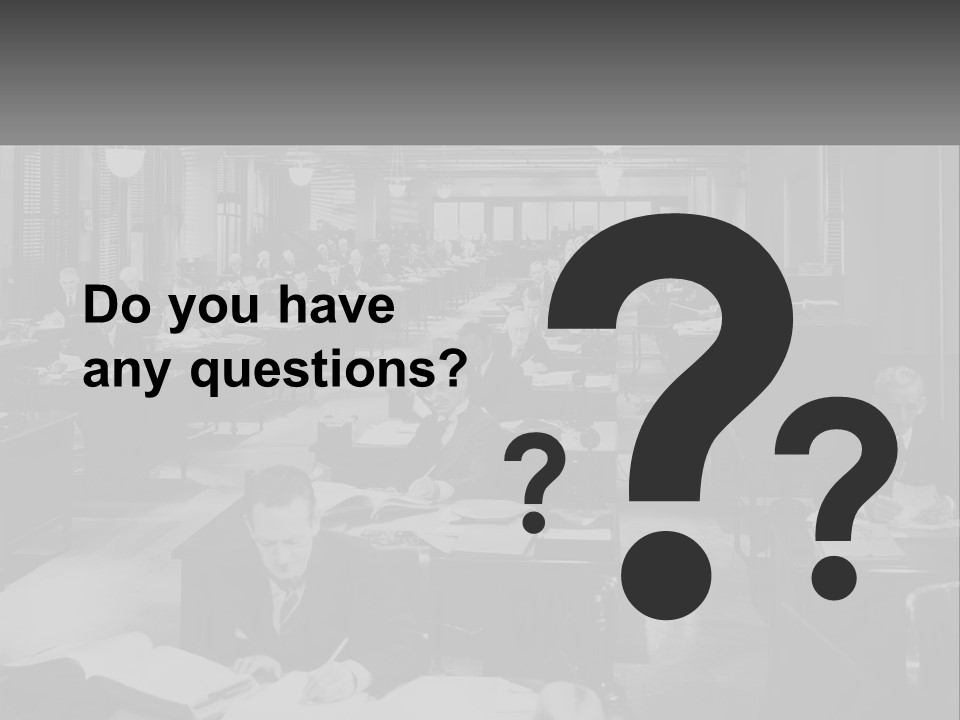 A Group Of People Sitting At Desks In A Room PowerPoint Template