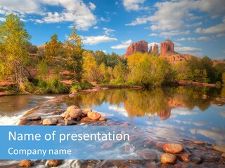 A River With Rocks And Trees In The Background PowerPoint Template