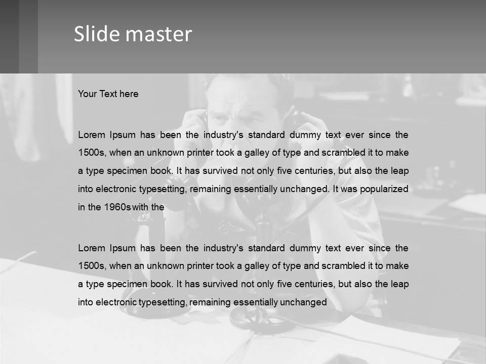 A Man Sitting At A Desk Talking On A Phone PowerPoint Template