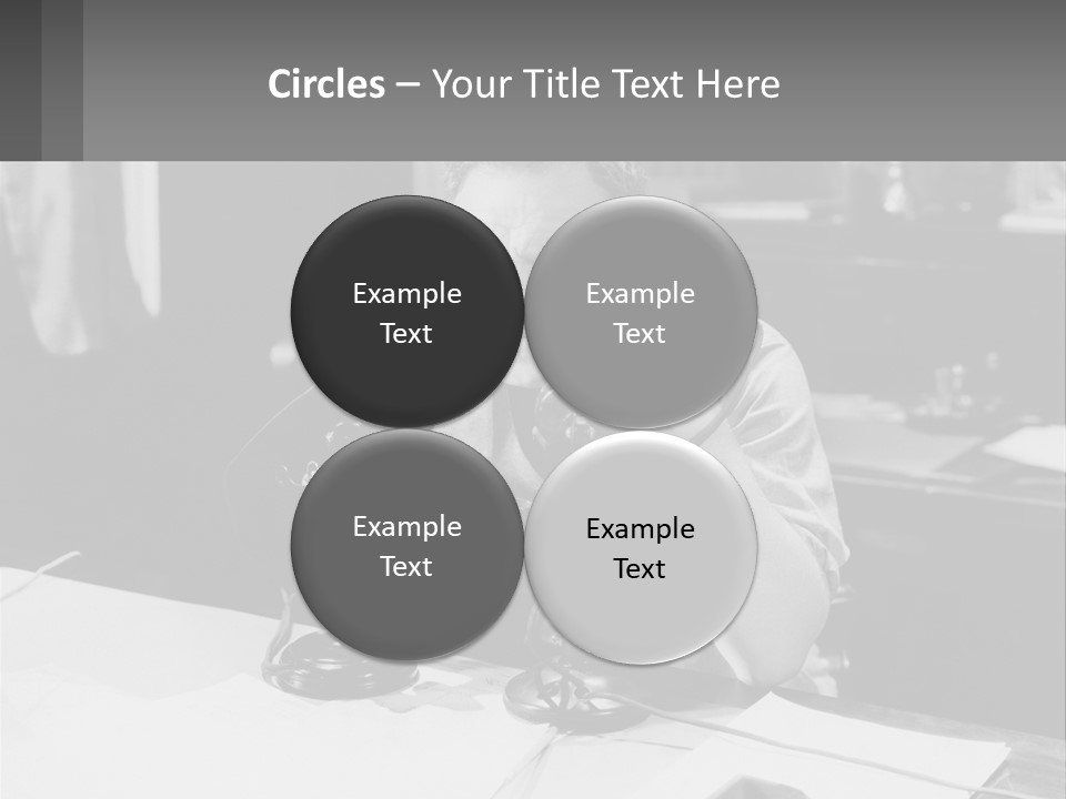 A Man Sitting At A Desk Talking On A Phone PowerPoint Template