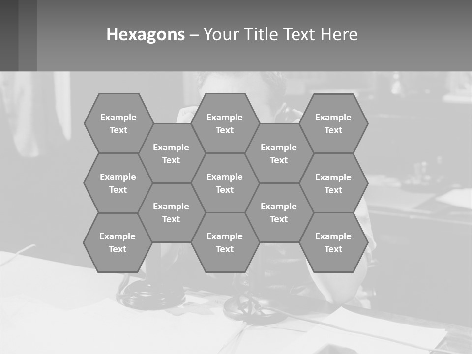 A Man Sitting At A Desk Talking On A Phone PowerPoint Template