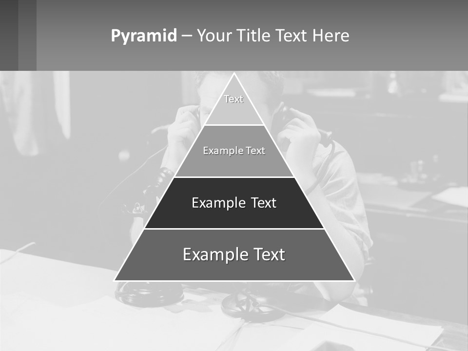 A Man Sitting At A Desk Talking On A Phone PowerPoint Template