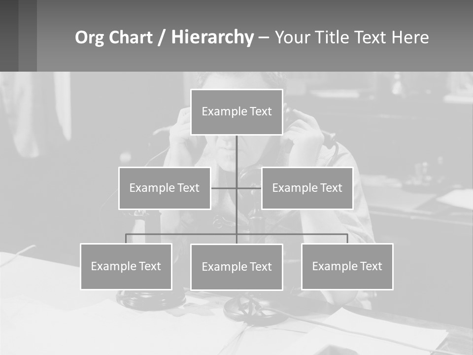 A Man Sitting At A Desk Talking On A Phone PowerPoint Template