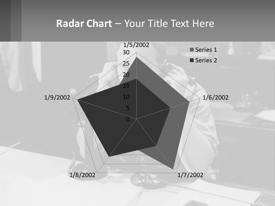 A Man Sitting At A Desk Talking On A Phone PowerPoint Template