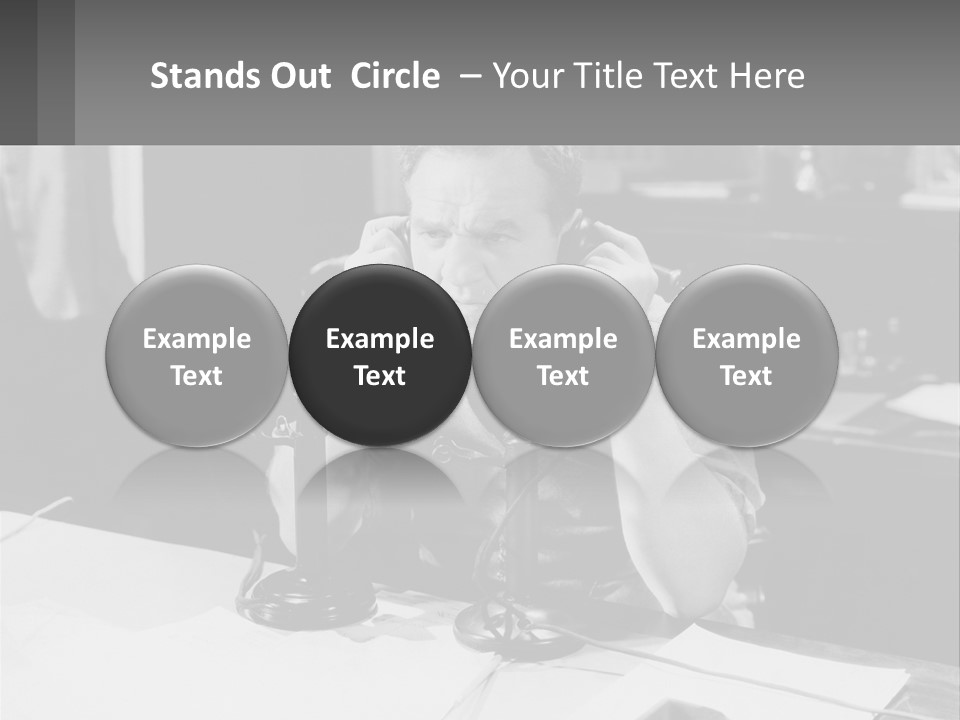 A Man Sitting At A Desk Talking On A Phone PowerPoint Template