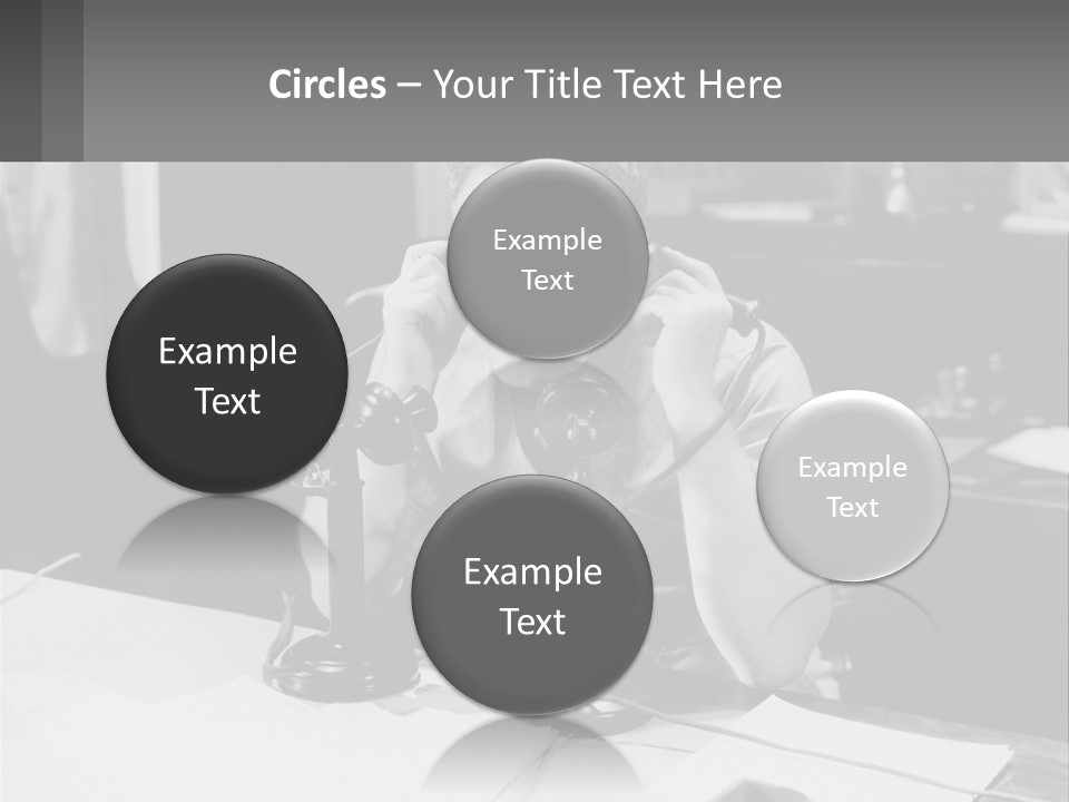 A Man Sitting At A Desk Talking On A Phone PowerPoint Template