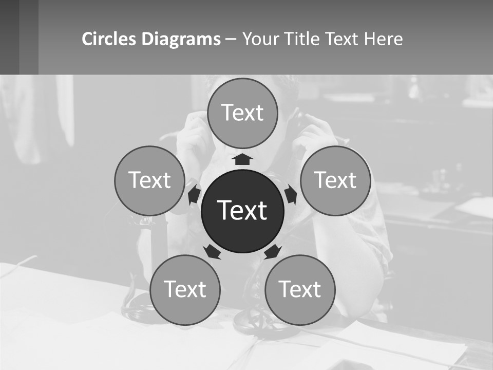 A Man Sitting At A Desk Talking On A Phone PowerPoint Template