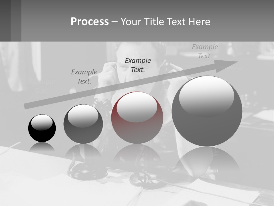 A Man Sitting At A Desk Talking On A Phone PowerPoint Template